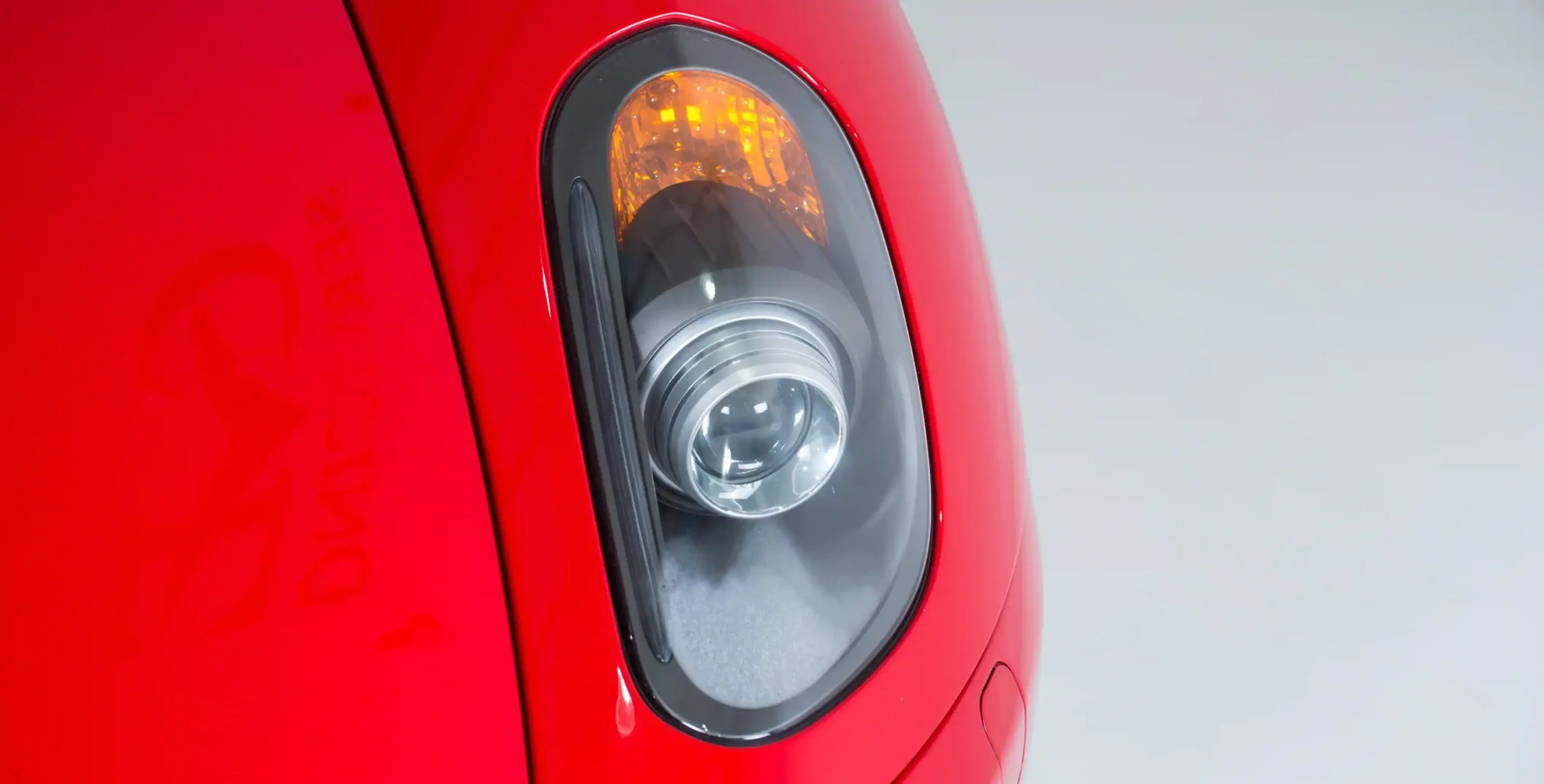 closeup-shot-headlights-modern-red-car (1)